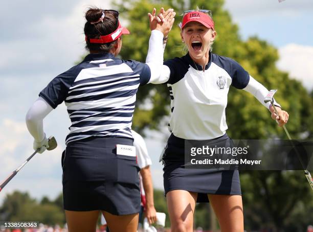 Megan Khang of Team USA reacts with Jessica Korda of Team USA after sinking a putt on the ninth hole during the Fourball Match on day two of the...