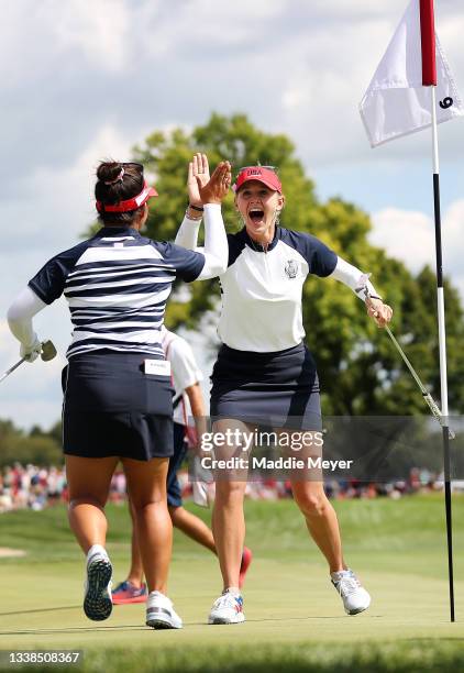 Megan Khang of Team USA reacts with Jessica Korda of Team USA after sinking a putt on the ninth hole during the Fourball Match on day two of the...