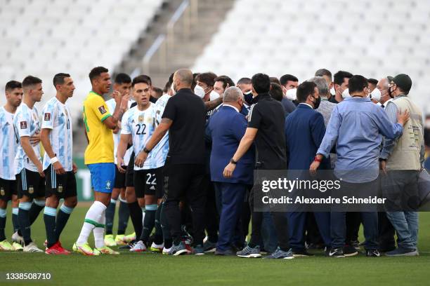 Health authorities interrupt the match as they argue with players of Argentina and Brazil during a match between Brazil and Argentina as part of...