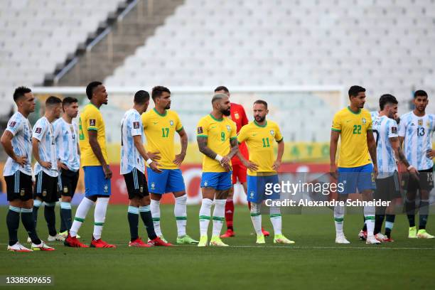 Players Argentina and Brazil wait as the match is delayed by Brazilian health authorities during a match between Brazil and Argentina as part of...