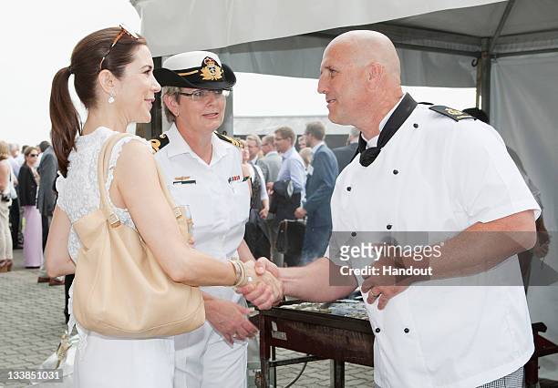 In this handout provided by the Royal Australian Navy, Princess Mary of Denmark, escorted by Commanding Officer of HMAS Kutabul, Commander Christine...