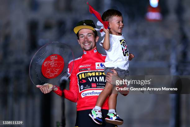 Primoz Roglic of Slovenia and Team Jumbo - Visma with his son Levom celebrate winning the red leader jersey on the podium ceremony in the Plaza del...