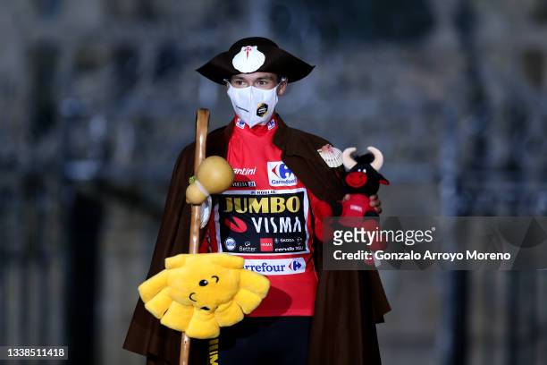 Primoz Roglic of Slovenia and Team Jumbo - Visma celebrates winning the red leader jersey dressed in " Camino de Santiago" pilgrim outfit on the...