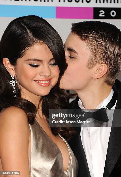 Singers Selena Gomez and Justin Bieber arrive at the 2011 American Music Awards held at Nokia Theatre L.A. LIVE on November 20, 2011 in Los Angeles,...