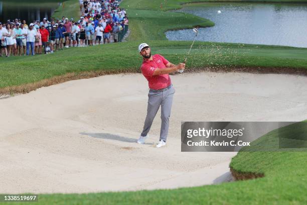 Jon Rahm of Spain plays a shot from a bunker on the ninth hole during the final round of the TOUR Championship at East Lake Golf Club on September...