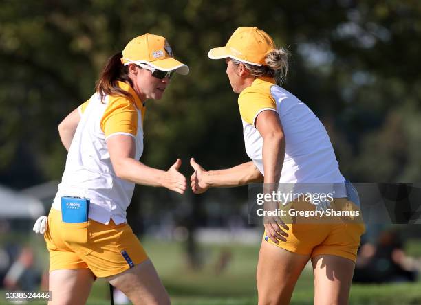 Mel Reid of Team Europe and Leona Maguire of Team Europe react on the 16th hole during the Fourball Match on day two of the Solheim Cup at the...