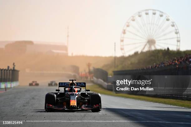 Race winner Max Verstappen of Netherlands and Red Bull Racing celebrates as he drives into parc ferme during the F1 Grand Prix of The Netherlands at...
