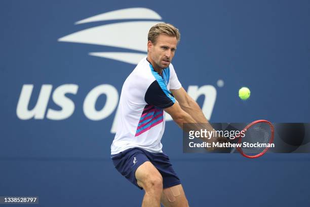Peter Gojowczyk of Germany returns against Carlos Alcaraz of Spain during his Men’s Singles round of 16 match on Day Seven at USTA Billie Jean King...