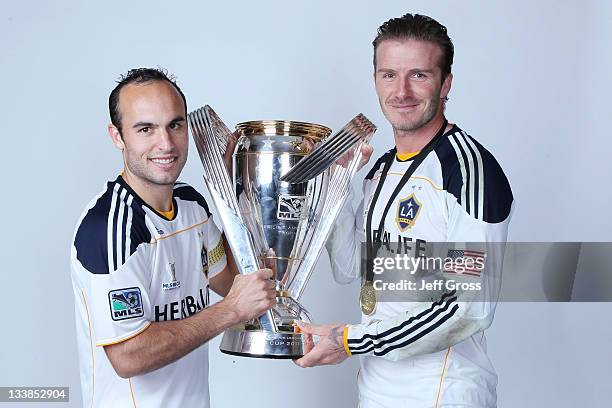 Landon Donovan and David Beckham of the Los Angeles Galaxy pose for a portrait following the 2011 MLS Cup at The Home Depot Center on November 20,...