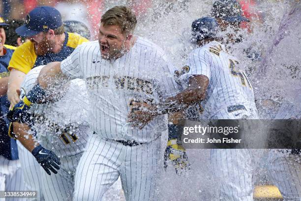Daniel Vogelbach of the Milwaukee Brewers gets a water and gatorade bath after hitting a walk-off grand slam in the ninth inning against the St....