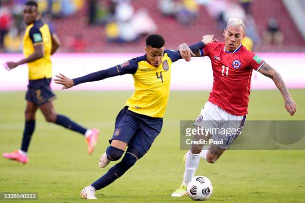 Byron Castillo of Ecuador competes for the ball with Eduardo Vargas of Chile during a match between Ecuador and Chile as part of South American...