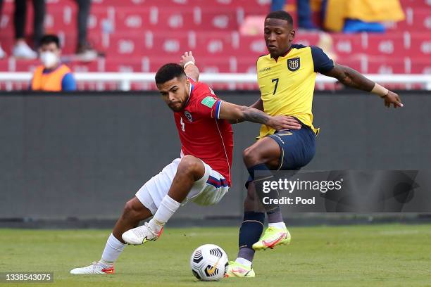 Paulo Díaz of Chile competes for the ball with Pervis Estupiñan of Ecuador during a match between Ecuador and Chile as part of South American...