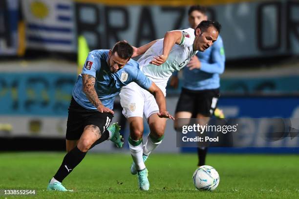 Gastón Pereiro of Uruguay competes for the ball with Leonel Justiniano of Bolivia during a match between Uruguay and Bolivia as part of South...