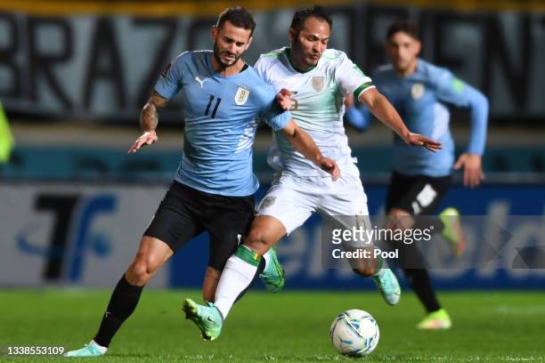 Gastón Pereiro of Uruguay competes for the ball with Leonel Justiniano of Bolivia during a match between Uruguay and Bolivia as part of South...