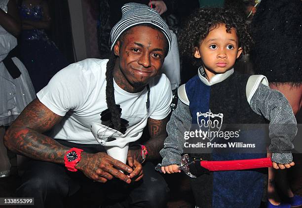 Dewayne "Lil Wayne" Carter and Dewayne Carter III attend Reginae Carter's 13th Birthday party at The Callanwolde Mansion on November 19, 2011 in...