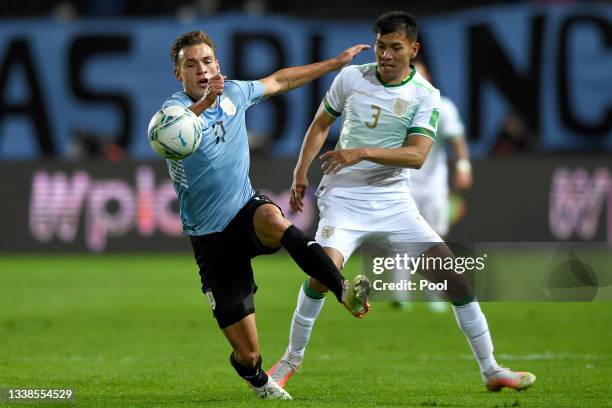 Gastón Pereiro of Uruguay competes for the ball with Jesús Sagredo of Bolivia during a match between Uruguay and Bolivia as part of South American...