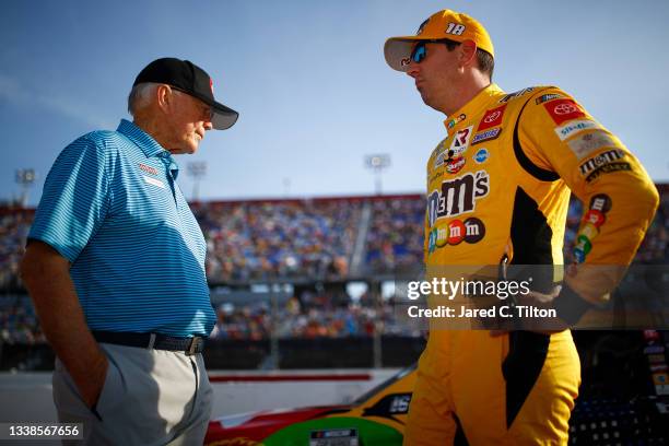 Kyle Busch, driver of the M&M's Toyota, and team owner and Hall of Famer Joe Gibbs talk on the grid prior to the NASCAR Cup Series Cook Out Southern...