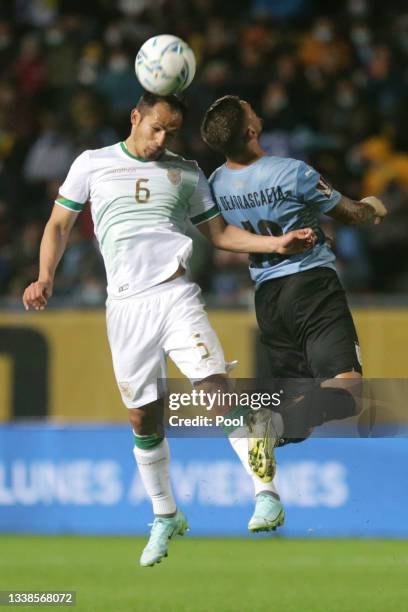 Leonel Justiniano of Bolivia heads the ball against Giorgian De Arrascaeta of Uruguay during a match between Uruguay and Bolivia as part of South...