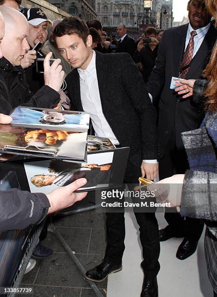 Actor Elijah Wood poses with fans at the "Happy Feet Two" european premiere at the Empire Leicester Square on November 20, 2011 in London,England.