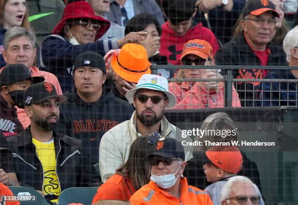 Klay Thompson of the NBA Golden State Warriors looks on from the stands during a game between the Los Angeles Dodgers and San Francisco Giants at...