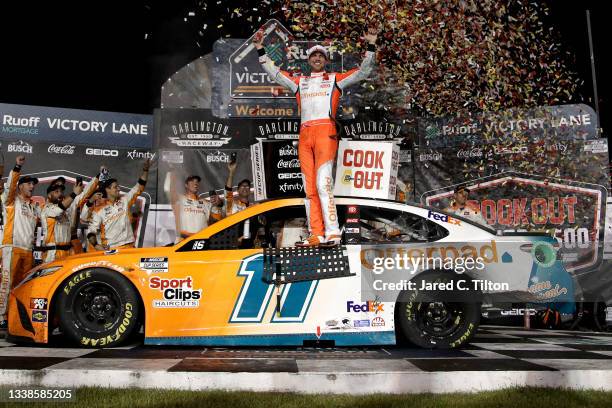 Denny Hamlin, driver of the Offerpad Toyota, celebrates in the Ruoff Mortgage victory lane after winning the NASCAR Cup Series Cook Out Southern 500...