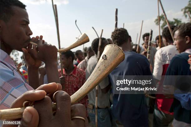 Boys with horns and sticks run about and sing in front of a Timkat procession during a Timkat festival in Lalibela on January 18, 2011 in Lalibela,...