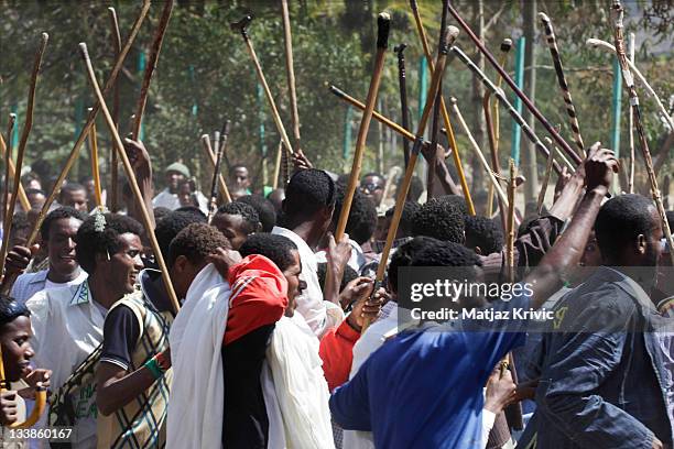 Boys with sticks running and singing in front of a Timkat procession during a Timkat festival in Lalibela on January 19, 2011 in Lalibela, Ethiopia.