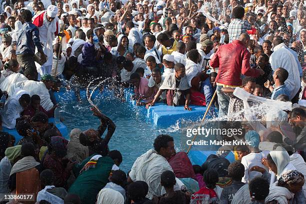 In the early hours of the morning, a body of water is blessed and the faithful re-enact the baptism of Christ on Timkat festival, in Lalibela January...