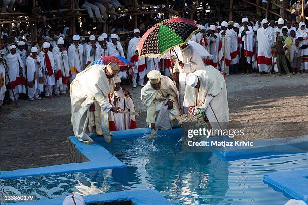 In the early hours of the morning, a body of water is blessed and the faithful re-enact the baptism of Christ on Timkat festival, in Lalibela January...