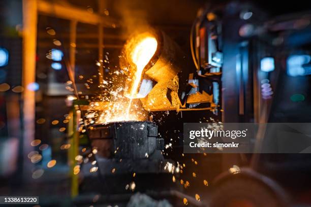 pouring of liquid molten metal to casting mold using forklift - molten stock pictures, royalty-free photos & images