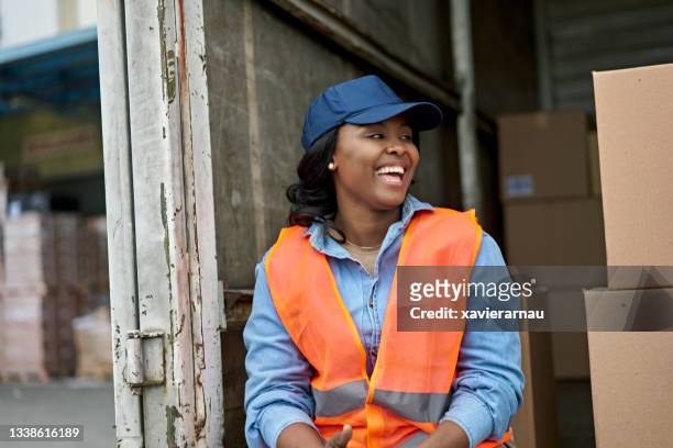 candid portrait of cheerful black female truck driver - wellbeing at work stock pictures, royalty-free photos & images