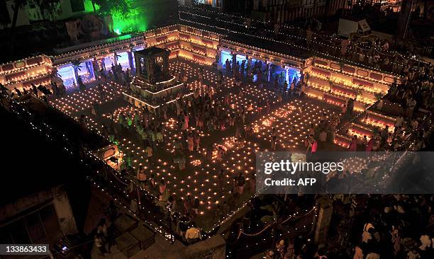 Devotees at a temple for the Hindu God Shiva take part in a Karthigai Deepam, a festival where they light oil wick lamps at the temple pond, in...