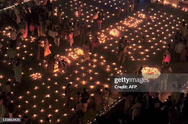 Devotees at a temple for the Hindu God Shiva take part in a Karthigai Deepam, a festival where they light oil wick lamps at the temple pond, in...