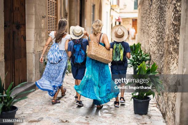 tourist family walking in the streets of beautiful spanish town - fashionable mom stock pictures, royalty-free photos & images