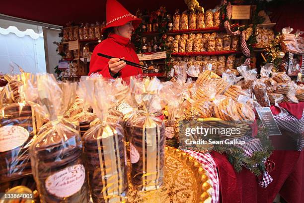 Stand hostess sells ginger bread cakes, or Lebkuchen, and other goodies at the Christmas market at Gendarmenmarkt square on the market's opening day...