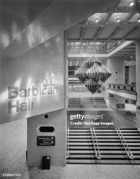 View from a high vantage point of the main foyer in the newly opened Barbican Centre, showing a sculpture suspended over the staircase and the...
