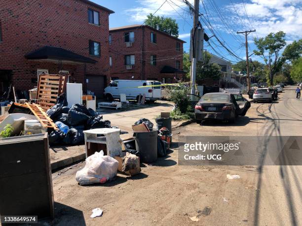 Debris removed from flooded homes and basements on the side of road waiting for sanitation department and flooded cars after Hurricanee Ida,...