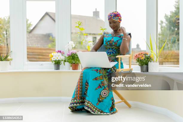 african lady working on her laptop - long dress stock pictures, royalty-free photos & images