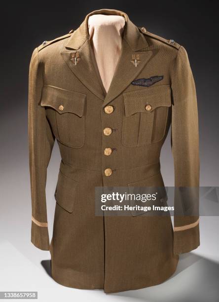 Officer's service coat, United States Army Air Corps, circa 1935. Wool uniform jacket; 4 brass buttons; open collar; 1st lt. Bars; olive drab color;...