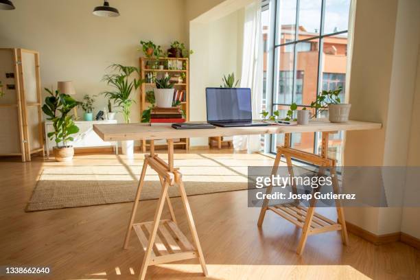 desktop for home office made by timber and sawhorses at an industrial loft with nordic furniture - feng shui house stock pictures, royalty-free photos & images