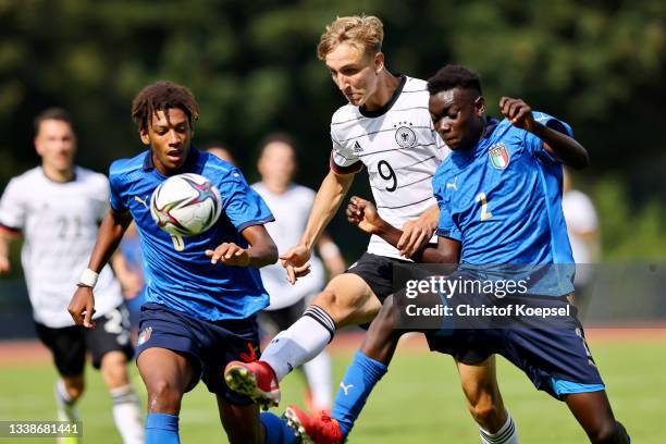 Filippo Calixte Mane of Italy and Mike Aidoo of Italy challenge Nelson Weiper of Germany of Germany during the KOMM MIT U17 Four Nations Tournament...