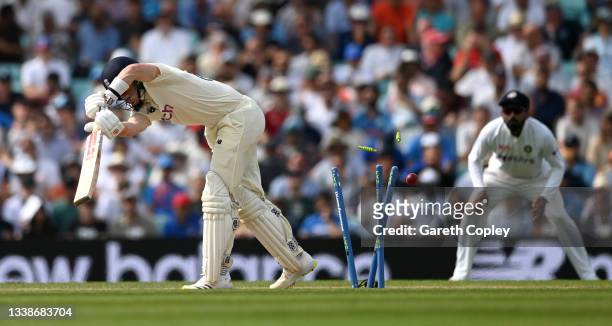 Ollie Pope of England is bowled by Jasprit Bumrah of India during day five of the Fourth LV= Insurance Test Match between England and India at The...