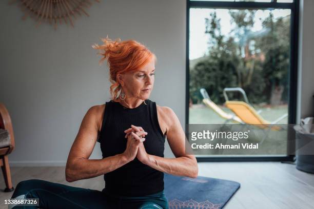 pilates instructor teaching an online class - senior colored hair stock pictures, royalty-free photos & images