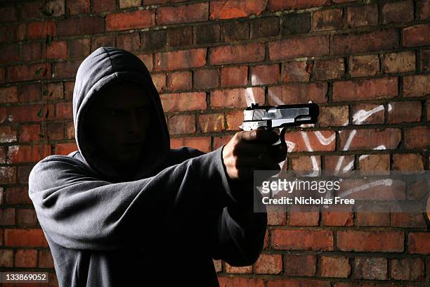 faceless gun toting hoodlum - shooting a weapon bildbanksfoton och bilder