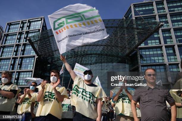 Striking members of the GDL union of locomotive drivers and railway personnel cheer as they listen to GDL head Claus Weselsky speak to them in front...