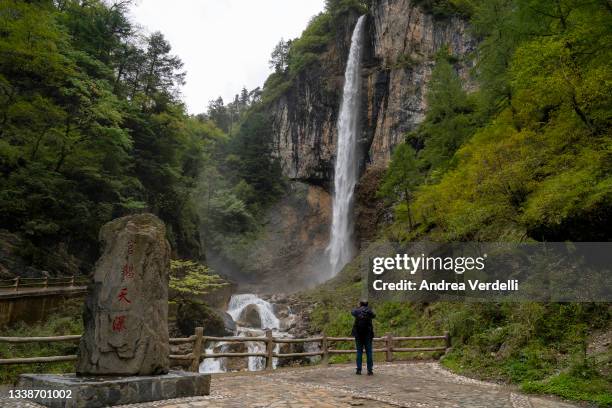 Man take a photo of Guaetian waterfall, during a state organized media trip to observe the development of the tourism industry of Tanchang County on...