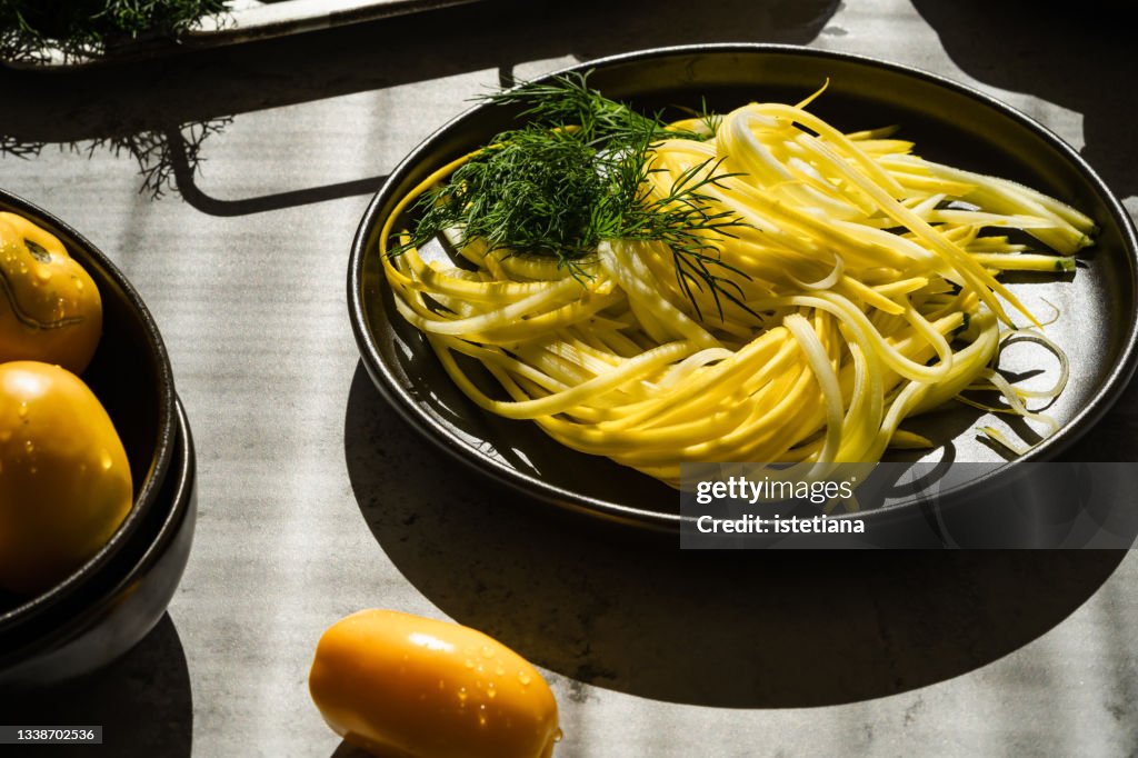 Raw organic yellow zucchini squash thinly sliced, zucchini noodles