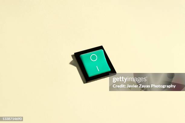 rocker switch on a pastel background. power-on position. - interruptor imagens e fotografias de stock