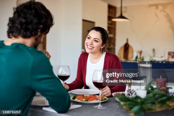 smiling girlfriend with boyfriend at home - romantic activity stock pictures, royalty-free photos & images