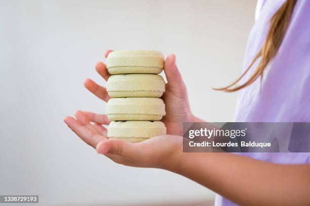 stack of organic soap and shampoo in hands - solid soap stock pictures, royalty-free photos & images